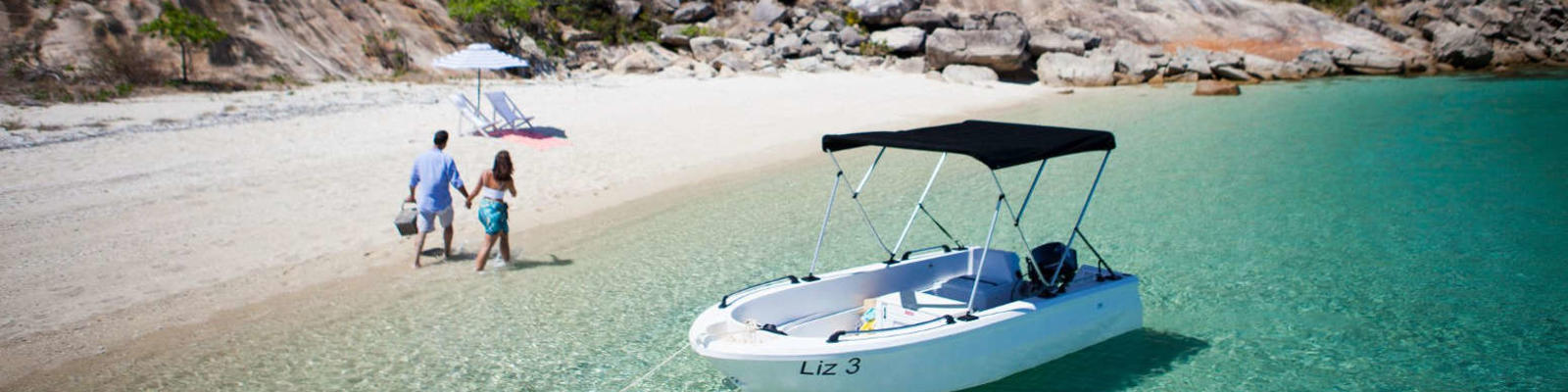 couple having picnic on secluded beach on lizard island qld