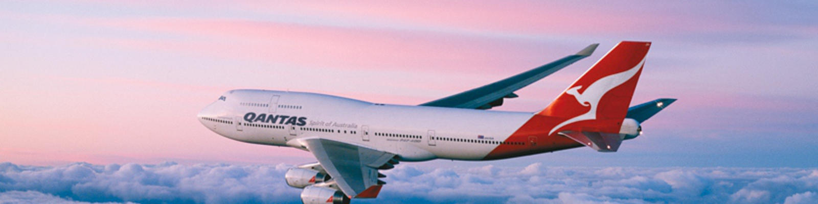 Qantas airplane flying over the purple and blue horizon