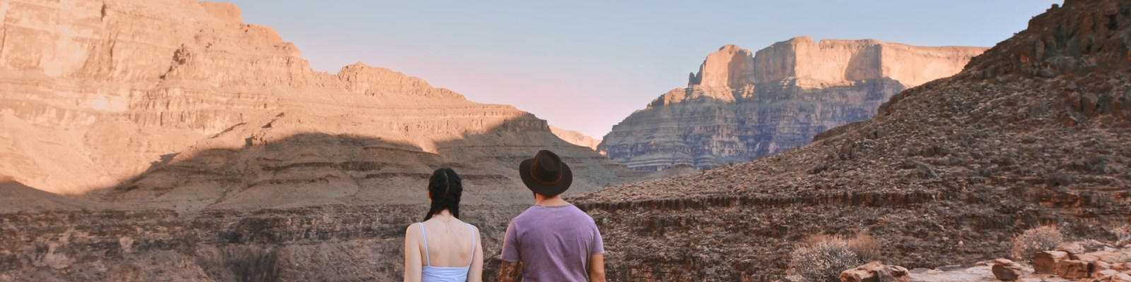 Two travellers at Grand Canyon looking out into the distance