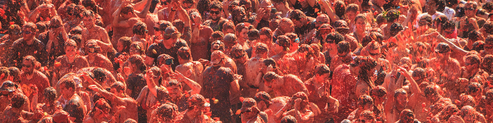 People throwing tomatoes at la tomatina festival in spain