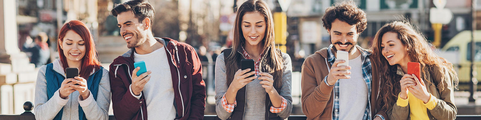 A group of travellers using their smartphones.