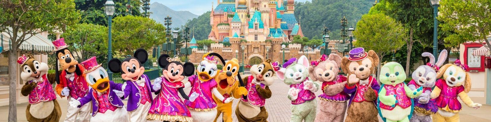 Disney characters at Hong Kong Disneyland in front of the Castle of Magical Dreams