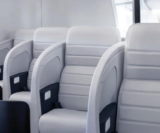 A view up the aisle of the Business Class cabin of an Air New Zealand plane