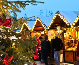 Christmas tree and people browsing the christmas market 