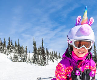 girl skiing on the slopes at Big White Cananda, dressed as a unicorn. Credit: Big White Ski Resort