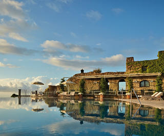 A stunning infinity edge pool reflecting the blue skies