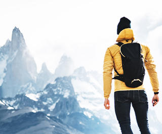A hiker looks at the looming El Chatan Peak in Patagonia