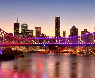 Brisbane's skyline, featuring the Story Bridge, at twilight.