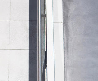 An overhead view of a woman running on a sidewalk
