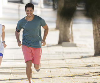 A man and a woman in jogging gear running down the street together