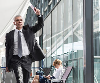 Two men running for their flight through the airport