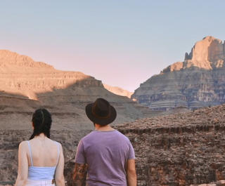 Two travellers at Grand Canyon looking out into the distance