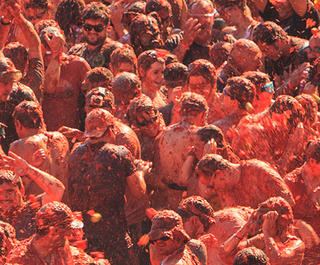 People throwing tomatoes at la tomatina festival in spain