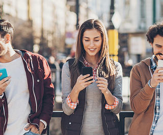 A group of travellers using their smartphones.