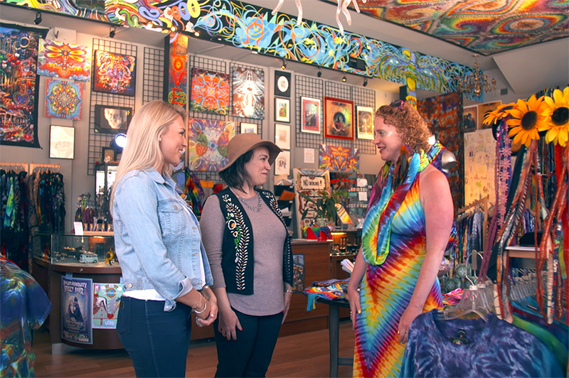 Three women stand inside the Love on Haight shop in San Francisco.