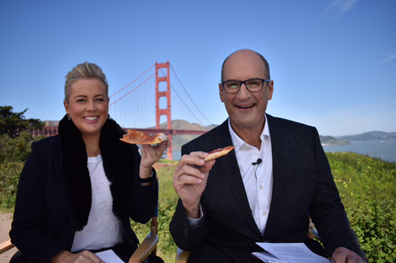 Samantha Armytage and David Koch eat pizza in front of the Golden Gate Bridge in San Francisco, USA.