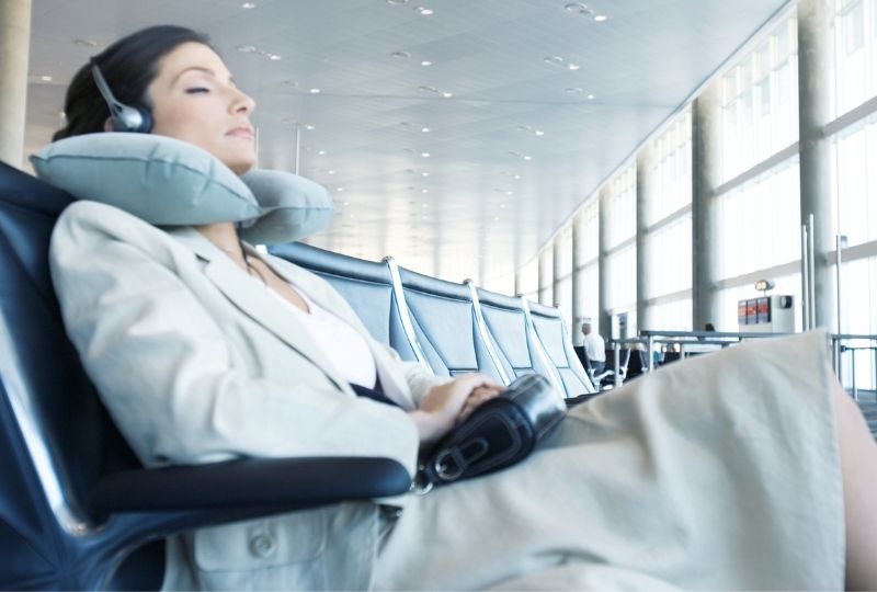 Image of business woman using a travel pillow