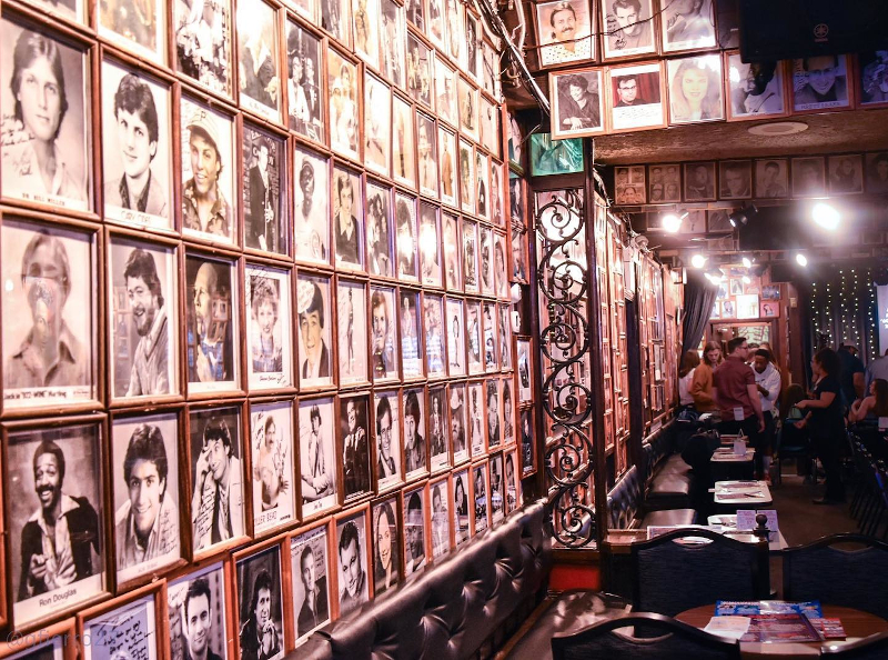 Inside Zaines Comedy Club with pictures of comedians all over the walls